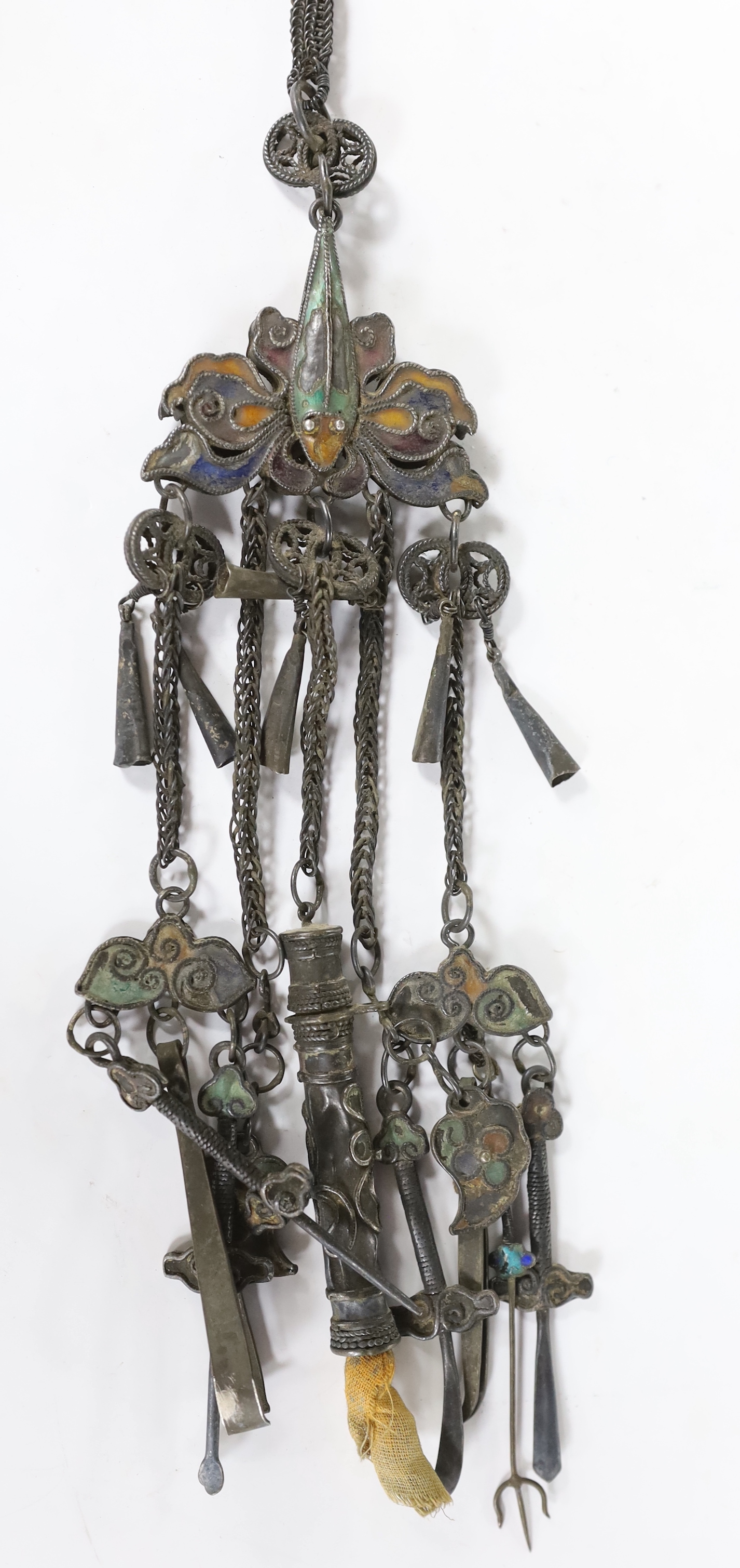 A 19th century continental white metal and polychrome enamel chatelaine, hung with assorted implements, 37cm.